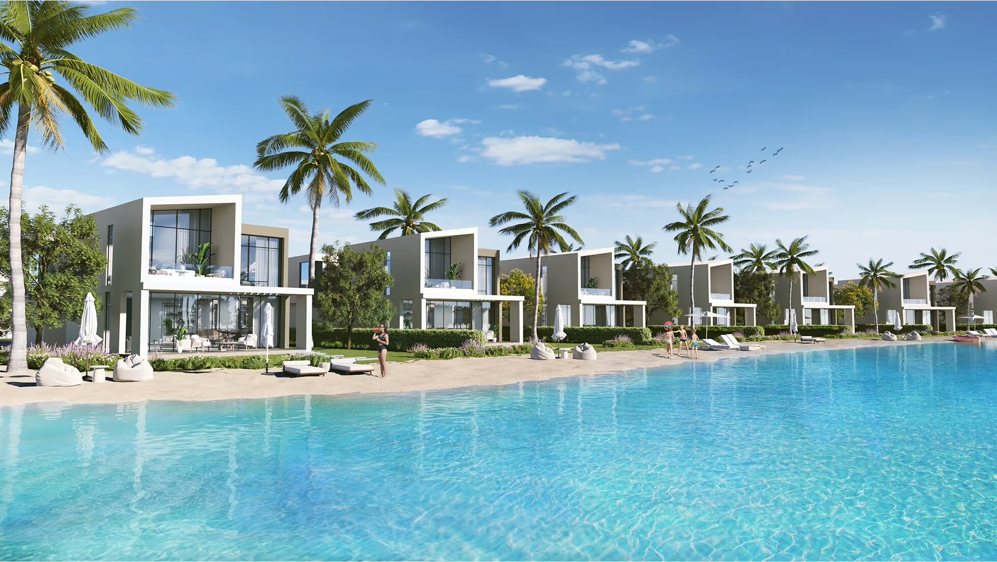 Golden-hour aerial view of Azha Ras El Hekma — crystal lagoons and a green valley by Madaar Developments