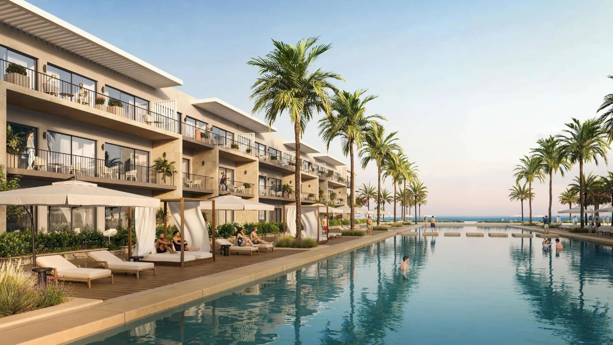 Chalets lining a long swimmable crystal lagoon that opens toward the sea at Silversands