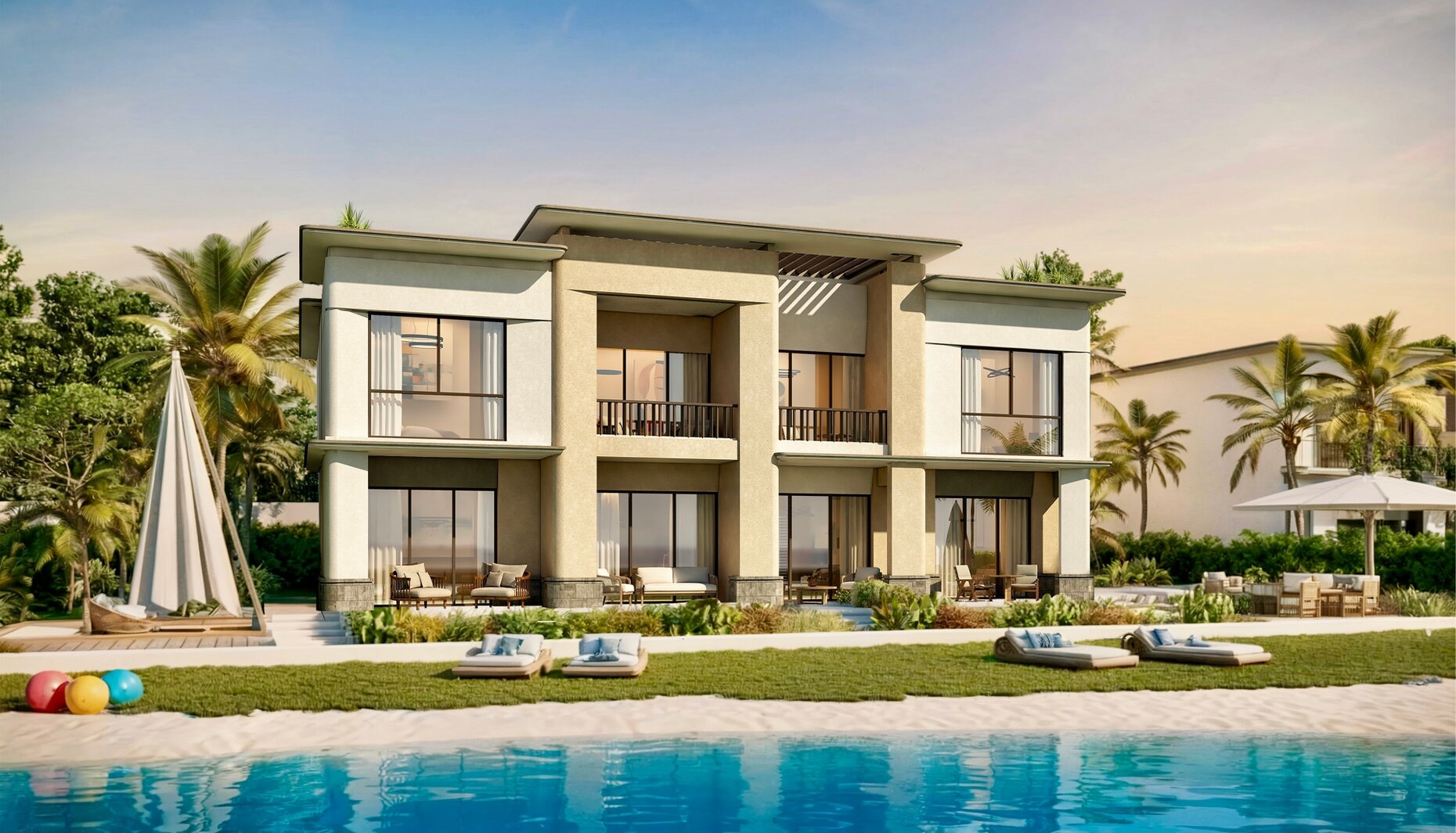 Beachfront home beside a pool at golden hour